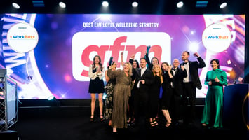 Team on stage winning an award